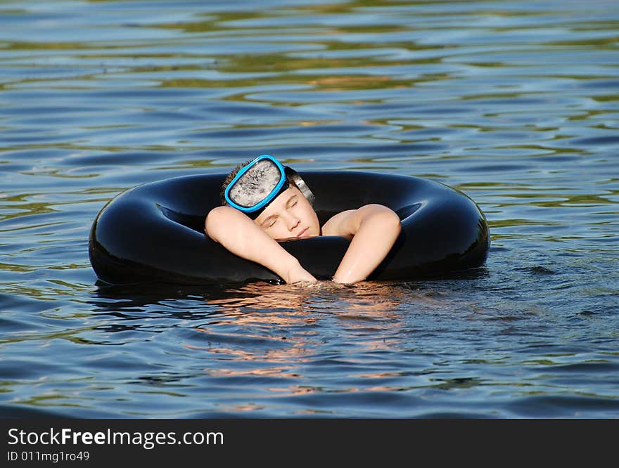 The boy got tired after swimming in a lake. The boy got tired after swimming in a lake.