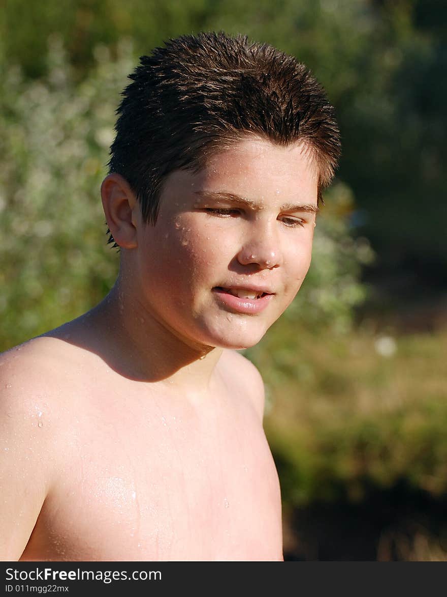 The portrait of the boy after he finished swimming in a lake. The portrait of the boy after he finished swimming in a lake.