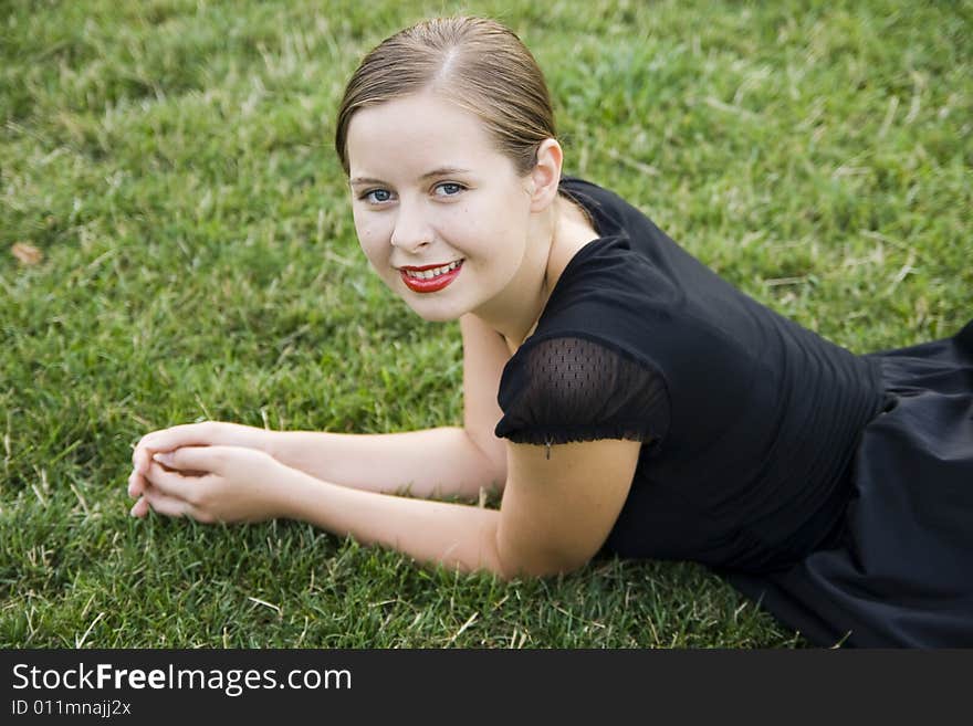 Young pretty smiling girl on lawn