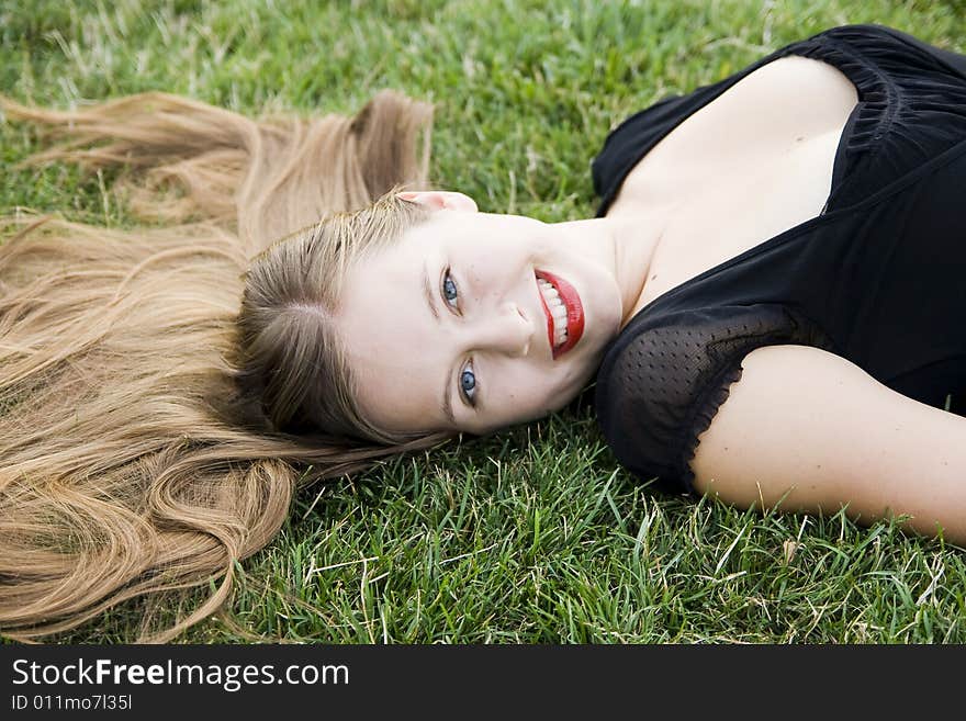 Cute smiling girl on lawn