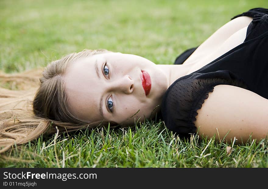 Young pretty smiling girl on lawn