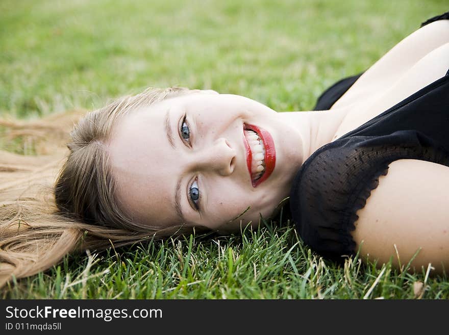 Laughing girl on green lawn