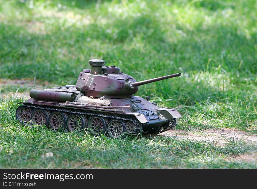 Toy tank on green grass