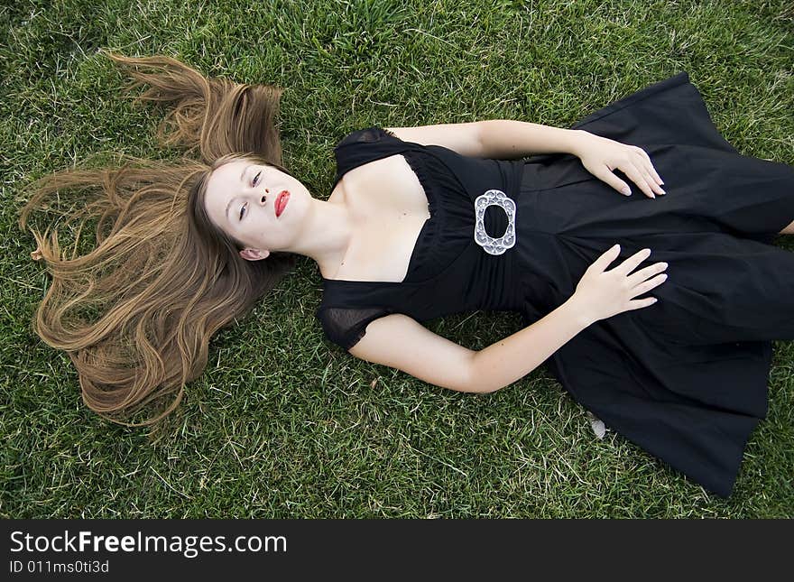 Young pretty smiling girl on lawn