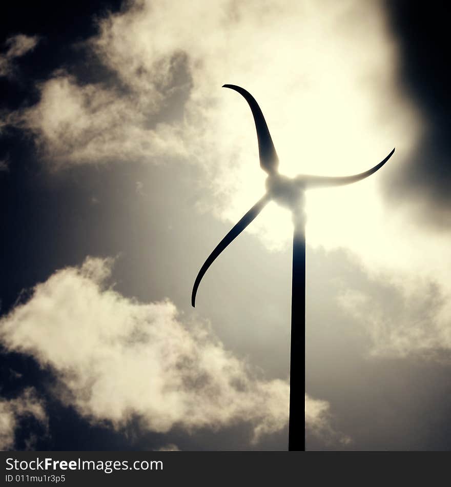 Wind generator with dramatic clouds in the background. Wind generator with dramatic clouds in the background.