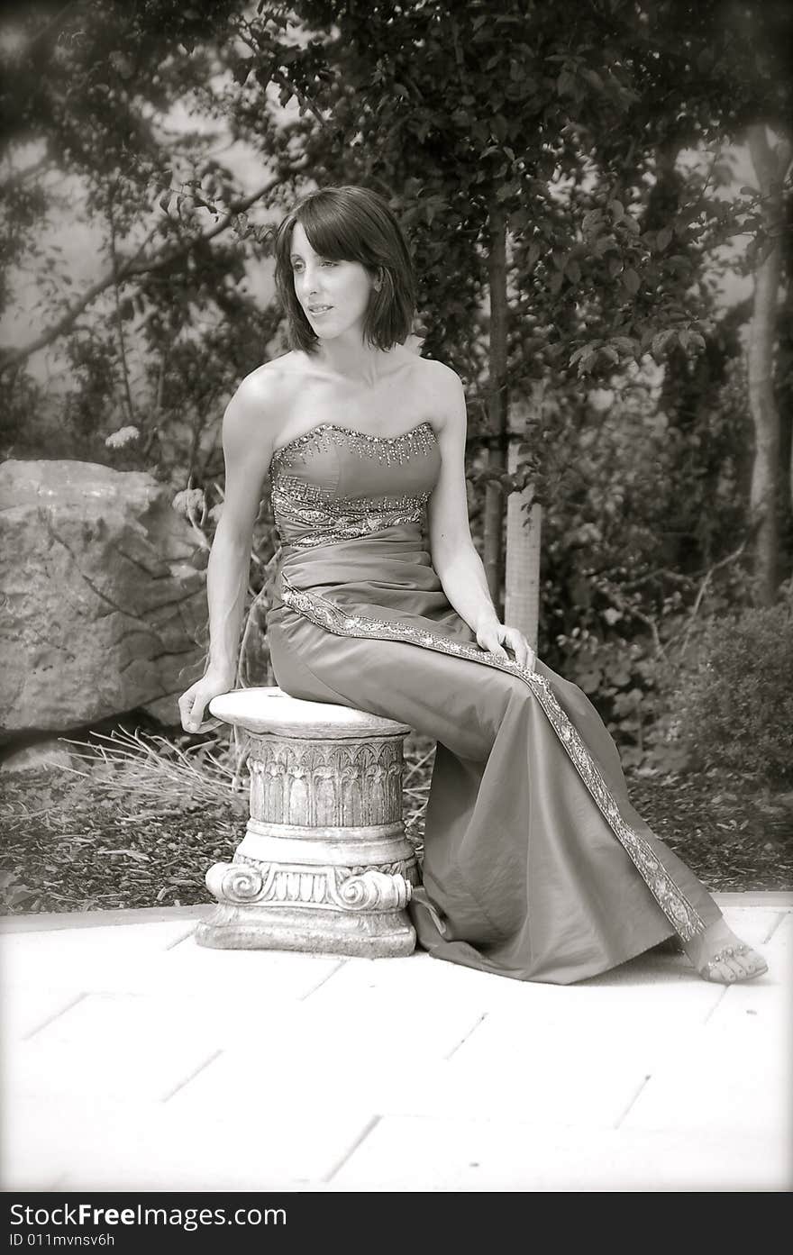 Glamor model posing on an old, antique stool. Glamor model posing on an old, antique stool.