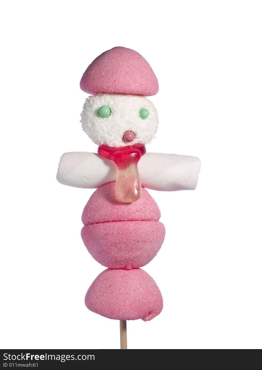 A male figurine made out of candies on a stick over a white background. A male figurine made out of candies on a stick over a white background.