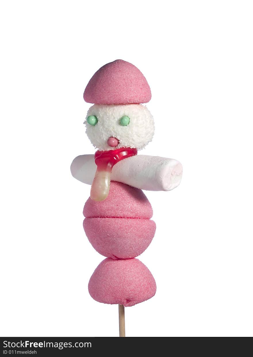 A male figurine made out of candies on a stick over a white background. A male figurine made out of candies on a stick over a white background.