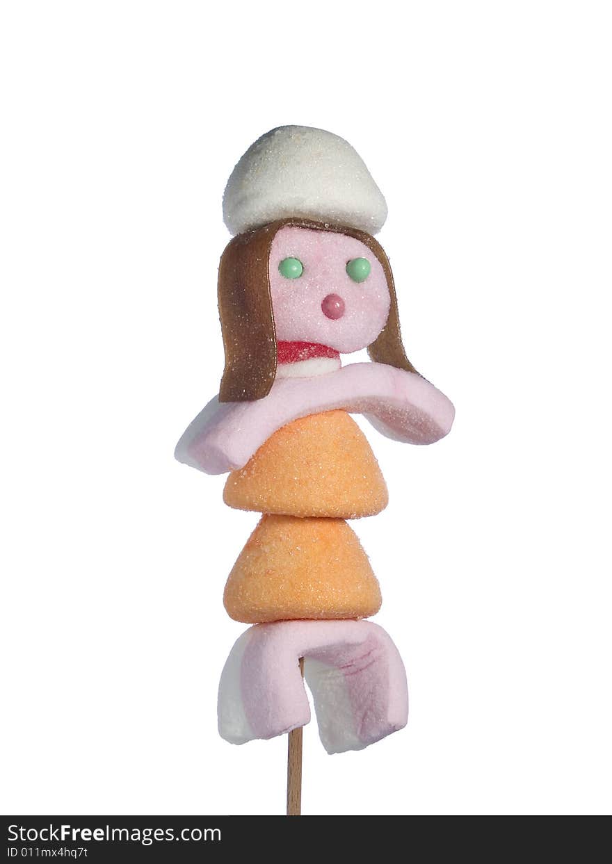 A female figurine made out of candies on a stick over a white background. A female figurine made out of candies on a stick over a white background.