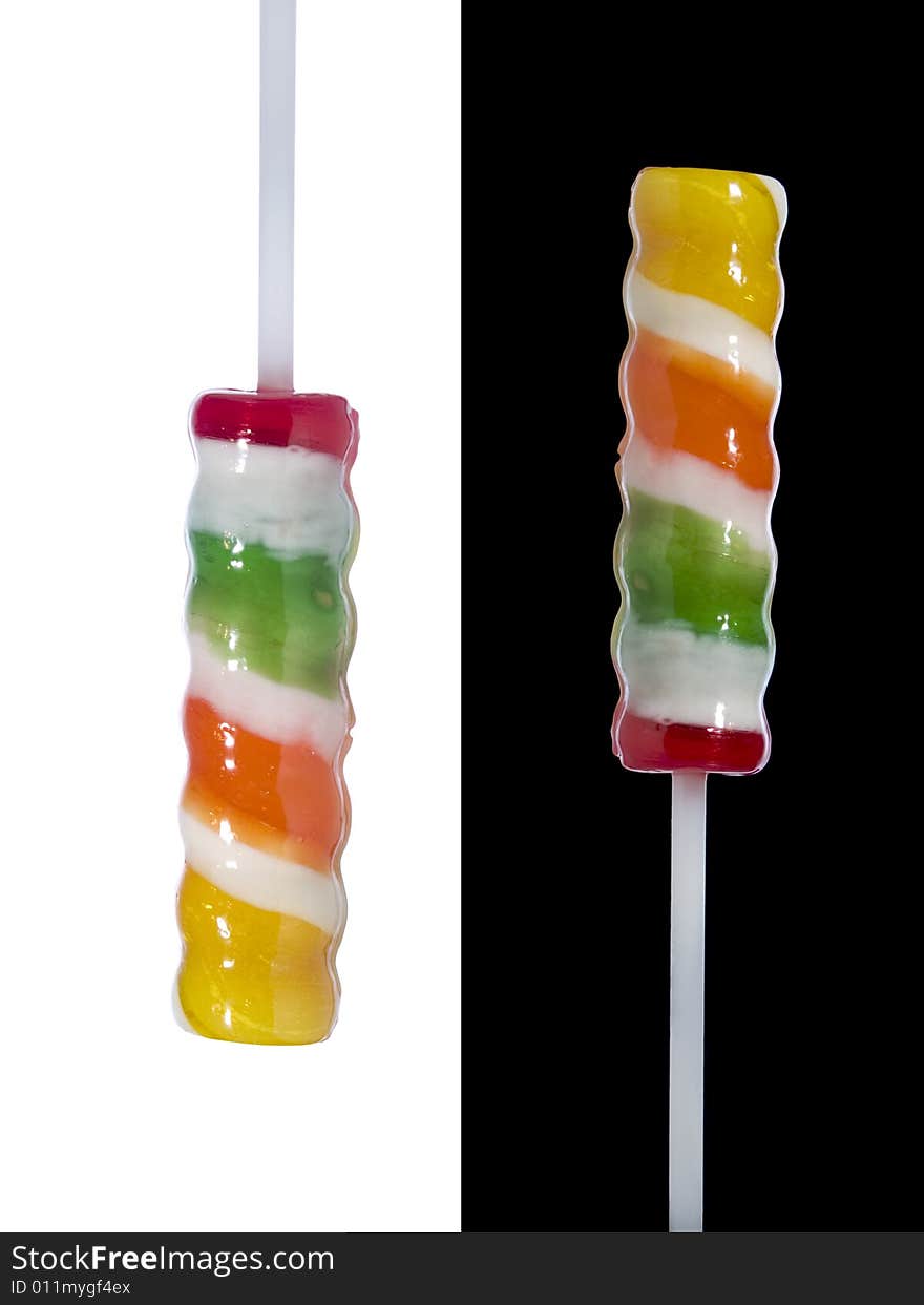 Two lollipop sticks pointing in opposite directions over black and white backgrounds respectively