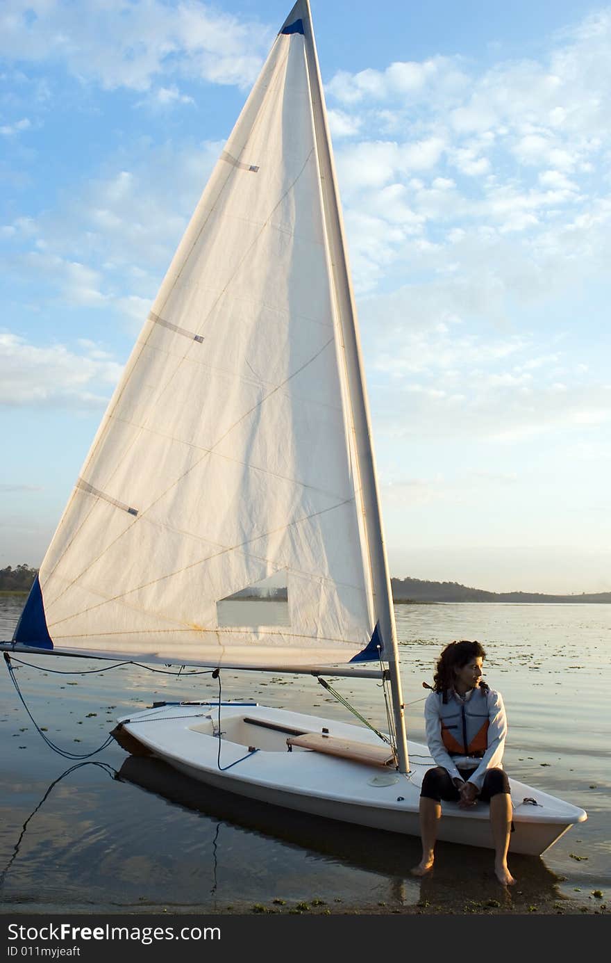 Woman Sitting on a Sailboat - Vertical