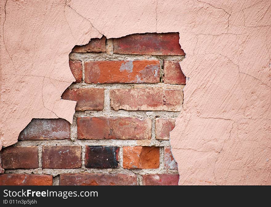 Plaster breaking away to reveal the brick wall underneath. Plaster breaking away to reveal the brick wall underneath