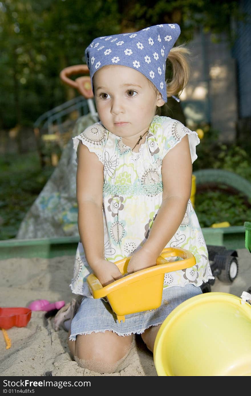 Little girl playing with truck