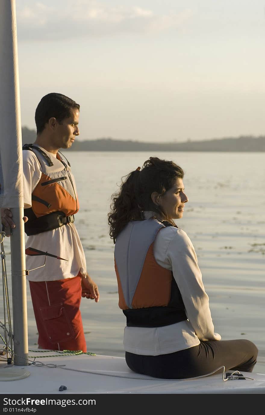 Couple Sitting On Sailboat - Vertical