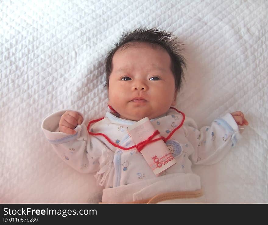 Infant and Money on a bed