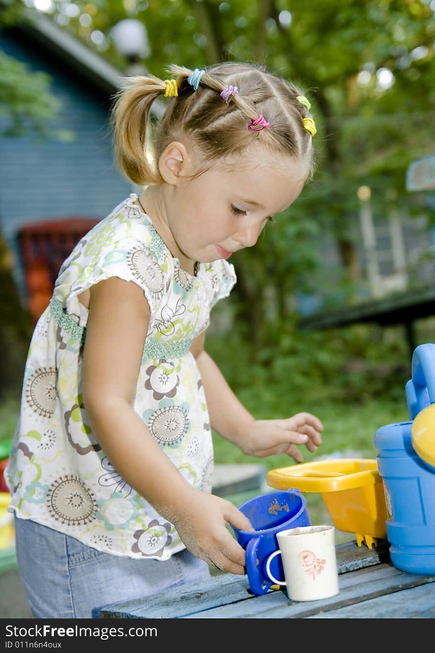 Little girl playing alone outdoor