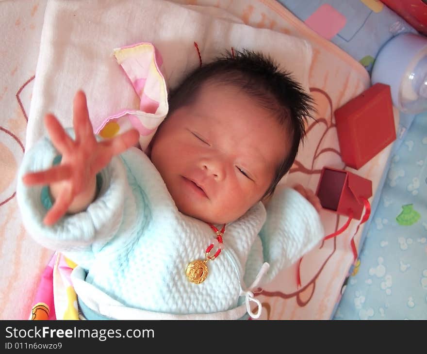 Infant and accessories on a bed