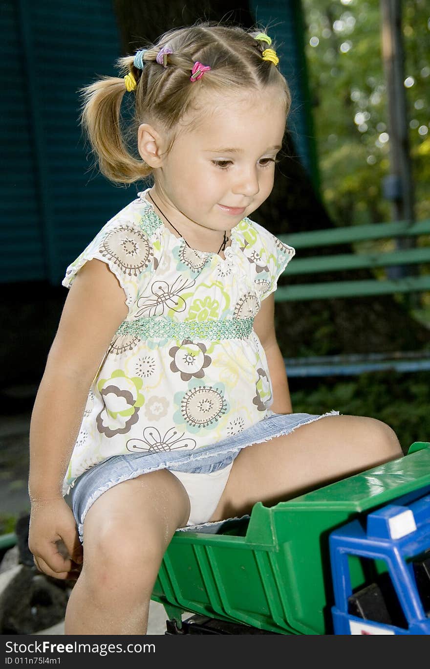 Little girl playing with truck