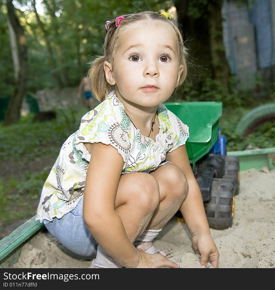 Little girl playing with truck