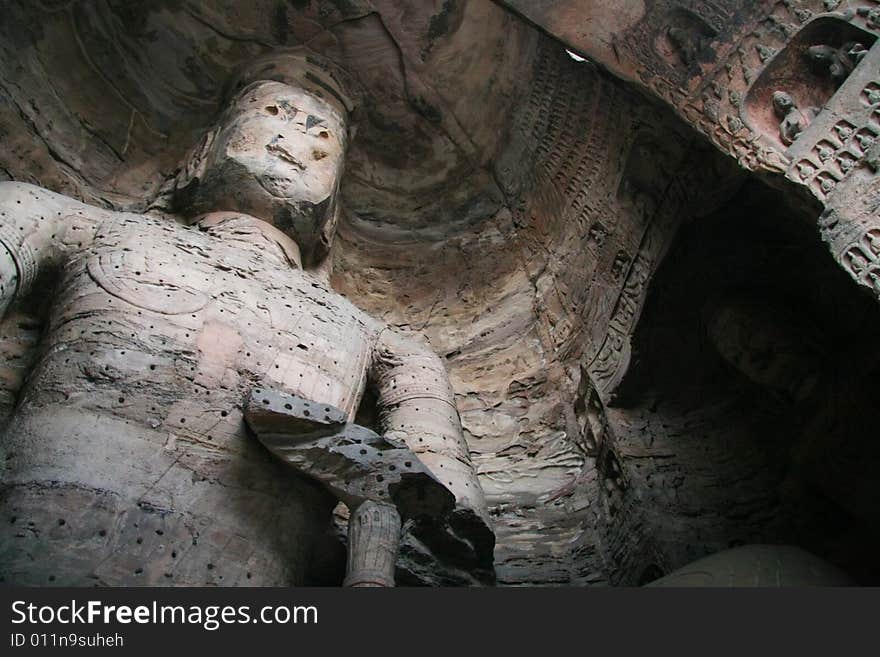 Stone carving in Yungang Grottoes, Datong, Shanxi province of China.

CAVE 17(A.D.460-465)
A crossed-legged Maitreya, 15.6 metres high, is carved on the north wall, a seated buddha on the east wall, and a standing buddha on the west wall, which are generally named The Trikala Buddhas. Stone carving in Yungang Grottoes, Datong, Shanxi province of China.

CAVE 17(A.D.460-465)
A crossed-legged Maitreya, 15.6 metres high, is carved on the north wall, a seated buddha on the east wall, and a standing buddha on the west wall, which are generally named The Trikala Buddhas.