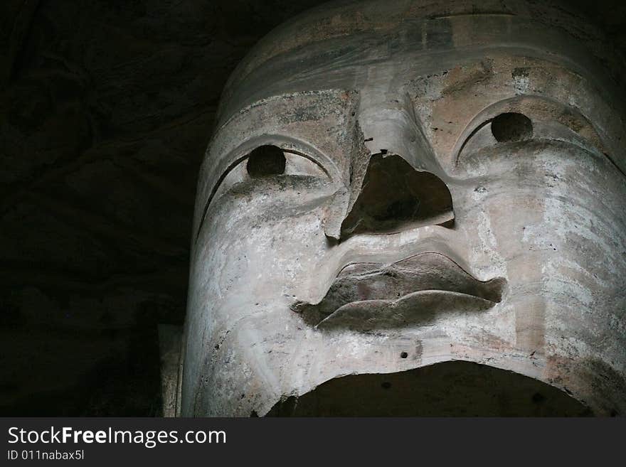 Stone carving in Yungang Grottoes, Datong, Shanxi province of China. CAVE 19(A.D.460-465) The main images are the Trikala buddhas. The seated Sakyamuni in the main cave is 16.8 metres high, the 2nd largest in the Yungang caves. Wearing a well-decorated kasaya. He has a squarely-round face, broad shoulders and long earlobes down to his shoulders. Stone carving in Yungang Grottoes, Datong, Shanxi province of China. CAVE 19(A.D.460-465) The main images are the Trikala buddhas. The seated Sakyamuni in the main cave is 16.8 metres high, the 2nd largest in the Yungang caves. Wearing a well-decorated kasaya. He has a squarely-round face, broad shoulders and long earlobes down to his shoulders.