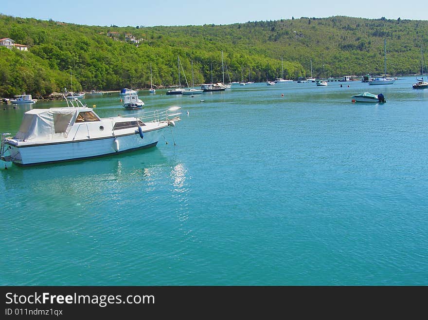 Trget and Rasa Bay (Istria - Croatia) postcard: beautiful landscape of a verdant Rasa River Bay with dock, fishing boats and yachts