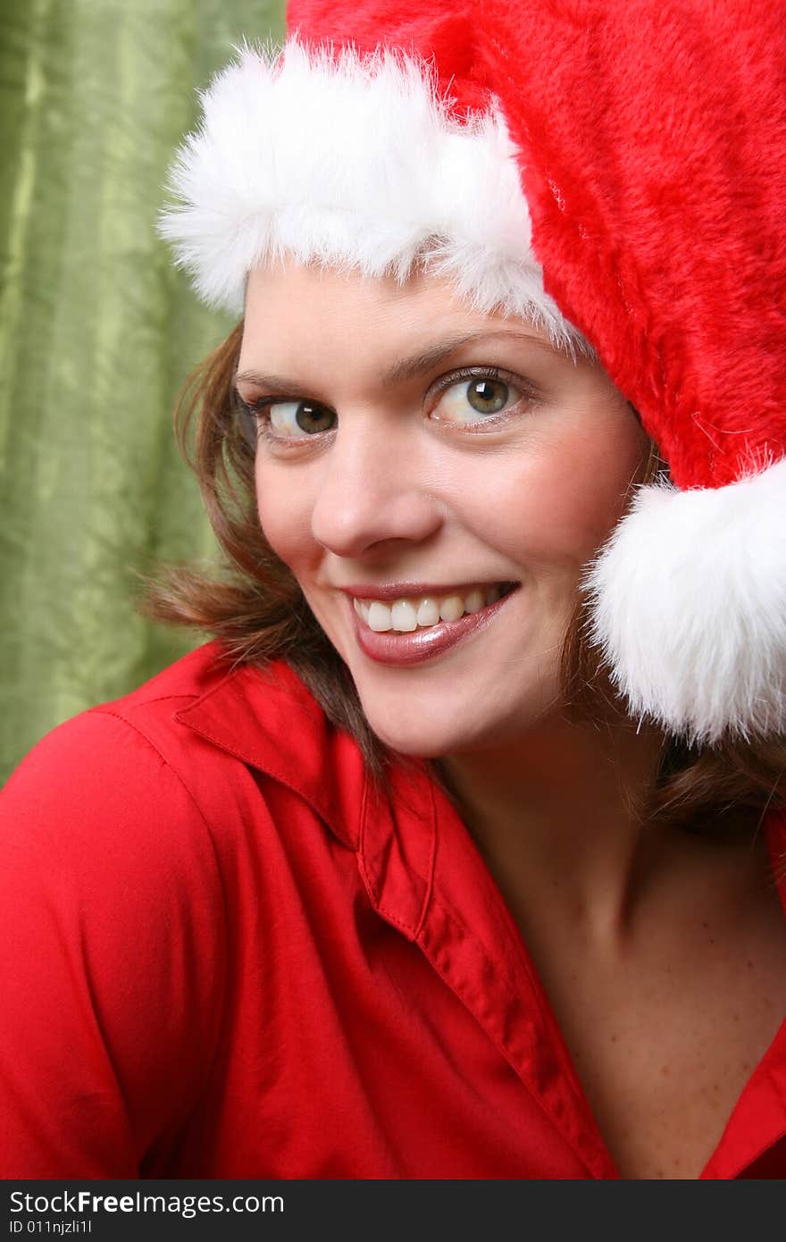 Beautiful Brunette model with a christmas hat and red top. Beautiful Brunette model with a christmas hat and red top