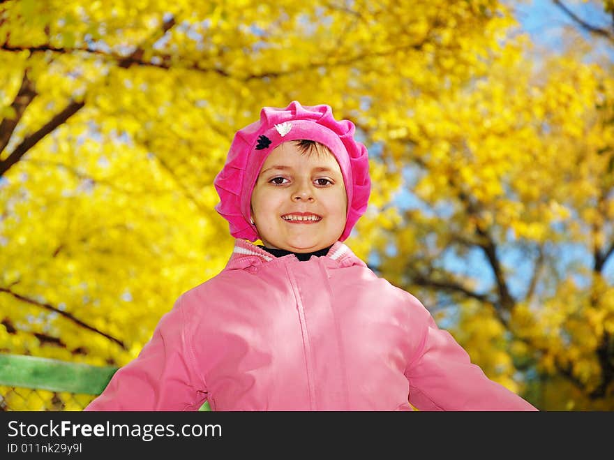 Pretty child over fall yellow tree