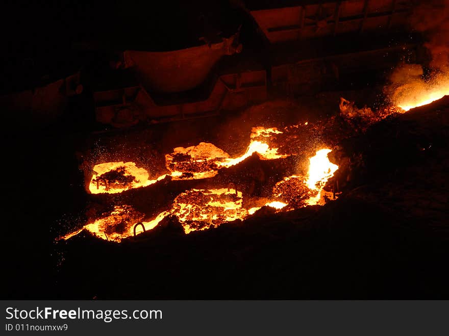 Glowing, molten hot steel. Stell casting. Glowing, molten hot steel. Stell casting.