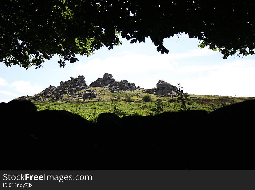 Hounds tor seen from woodland. dartmoor. devon. Hounds tor seen from woodland. dartmoor. devon.