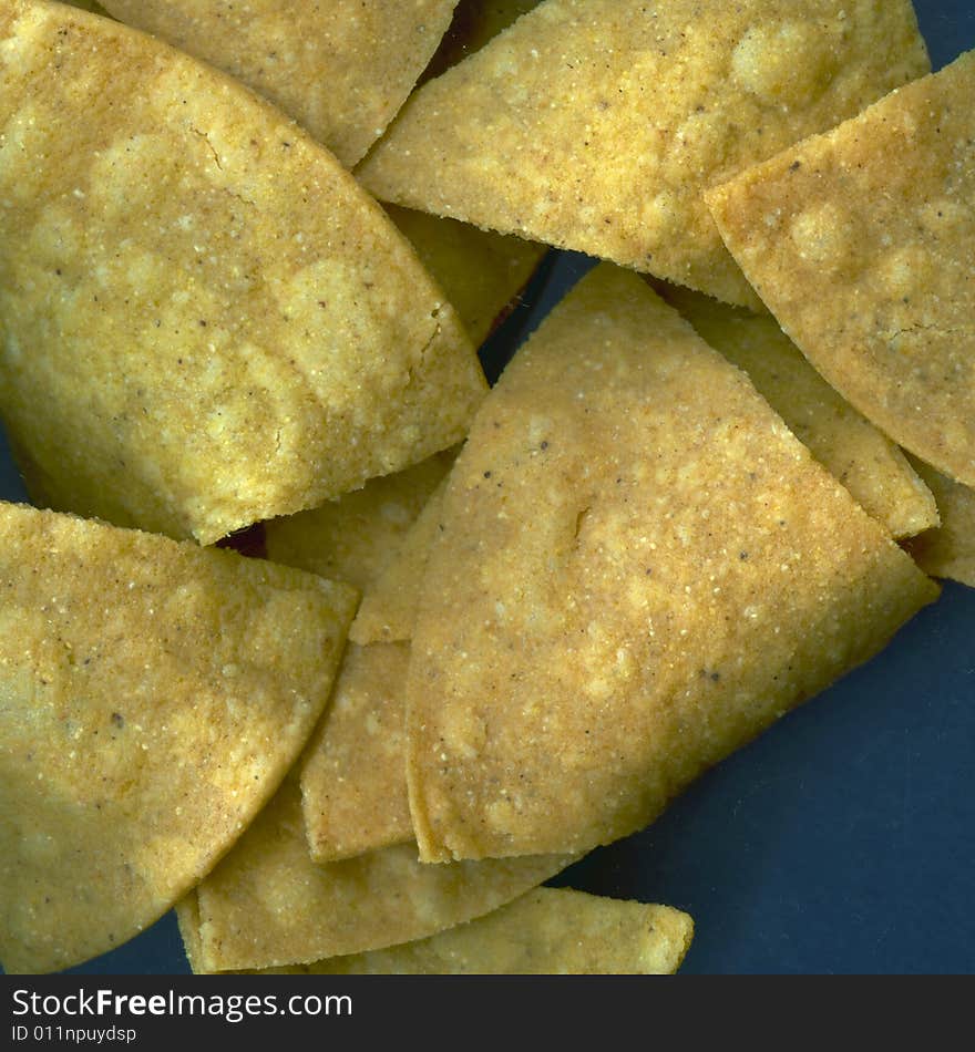 Isolated Tortilla Chips on a Navy Blue Field