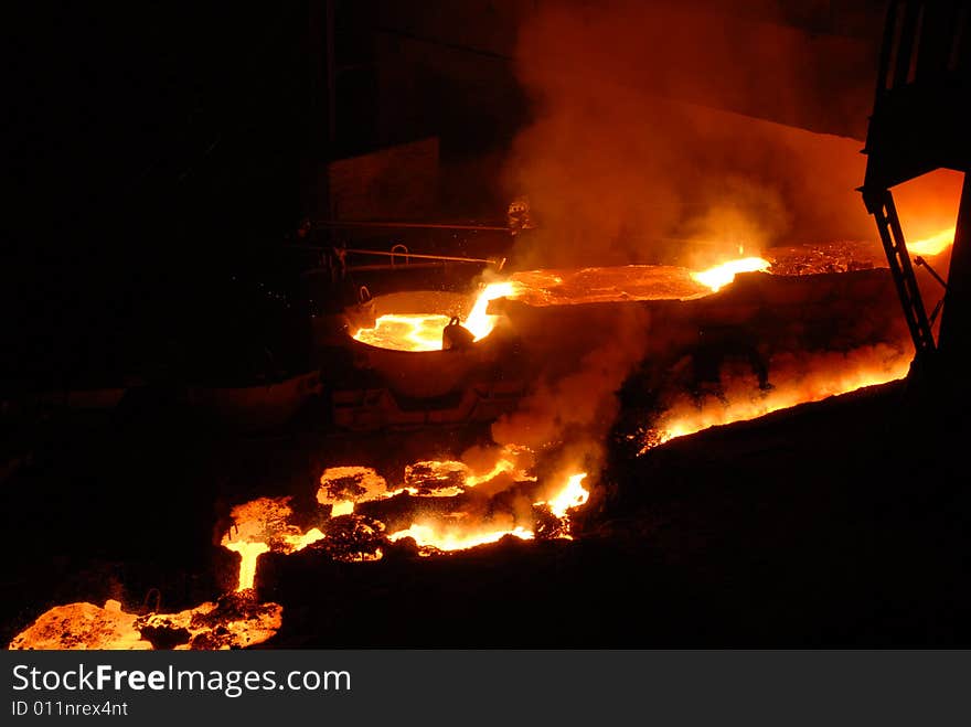 Glowing, molten hot steel. Stell casting. Glowing, molten hot steel. Stell casting.