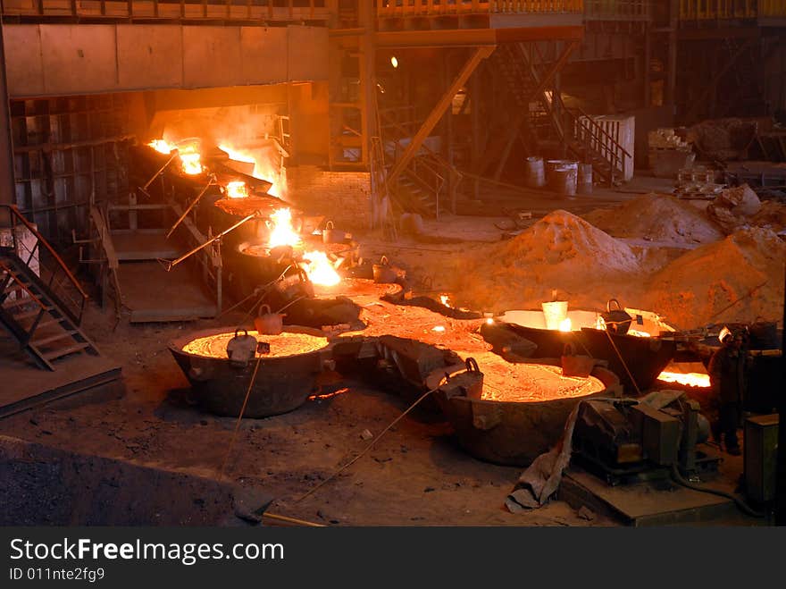 Glowing, molten hot steel. Stell casting. Glowing, molten hot steel. Stell casting.