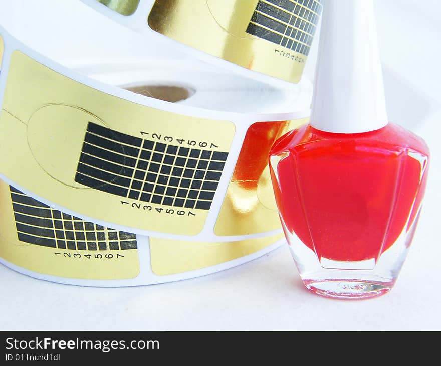 Red nail polish on a white background