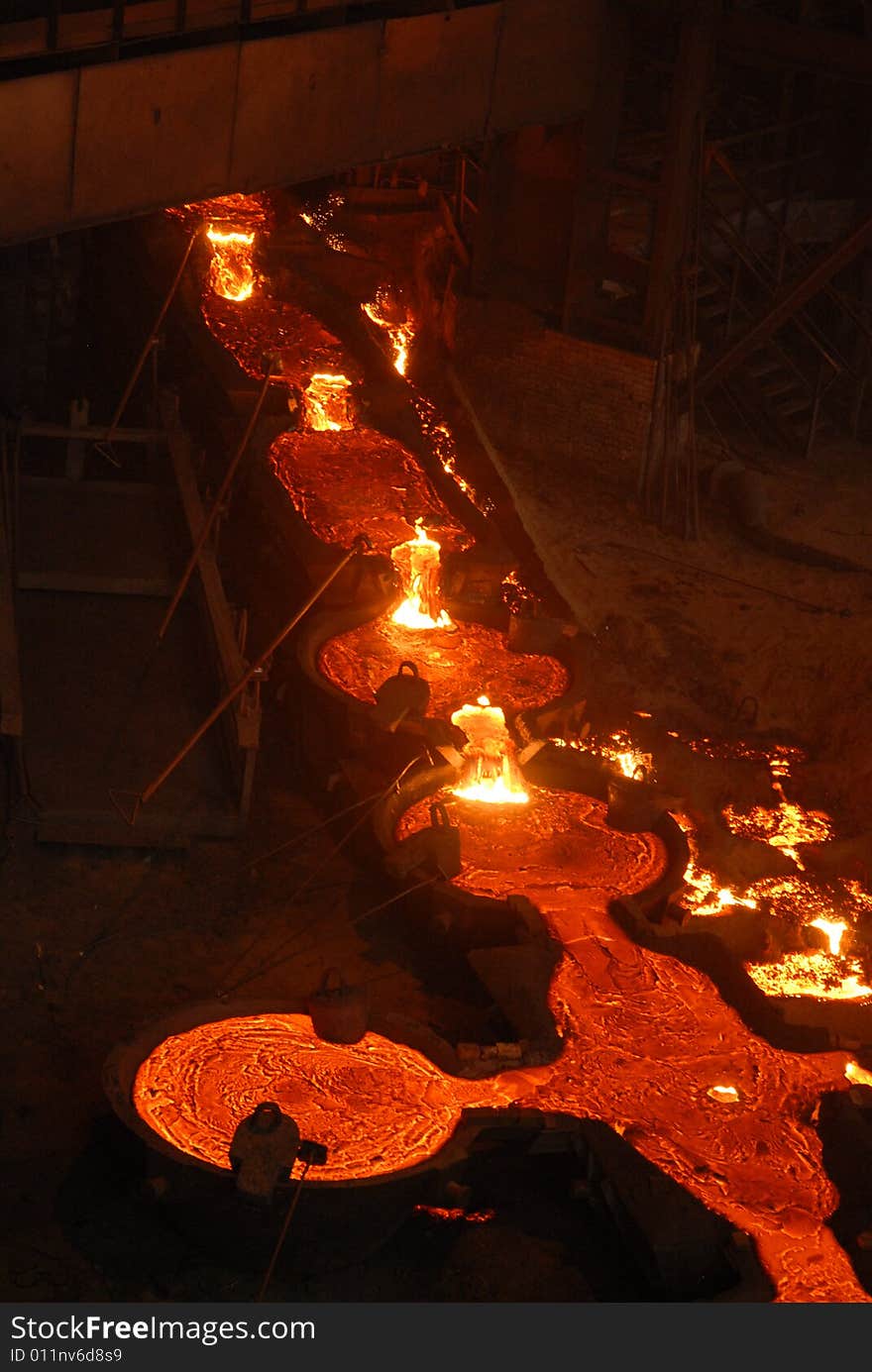 Glowing, molten hot steel. Stell casting. Glowing, molten hot steel. Stell casting.