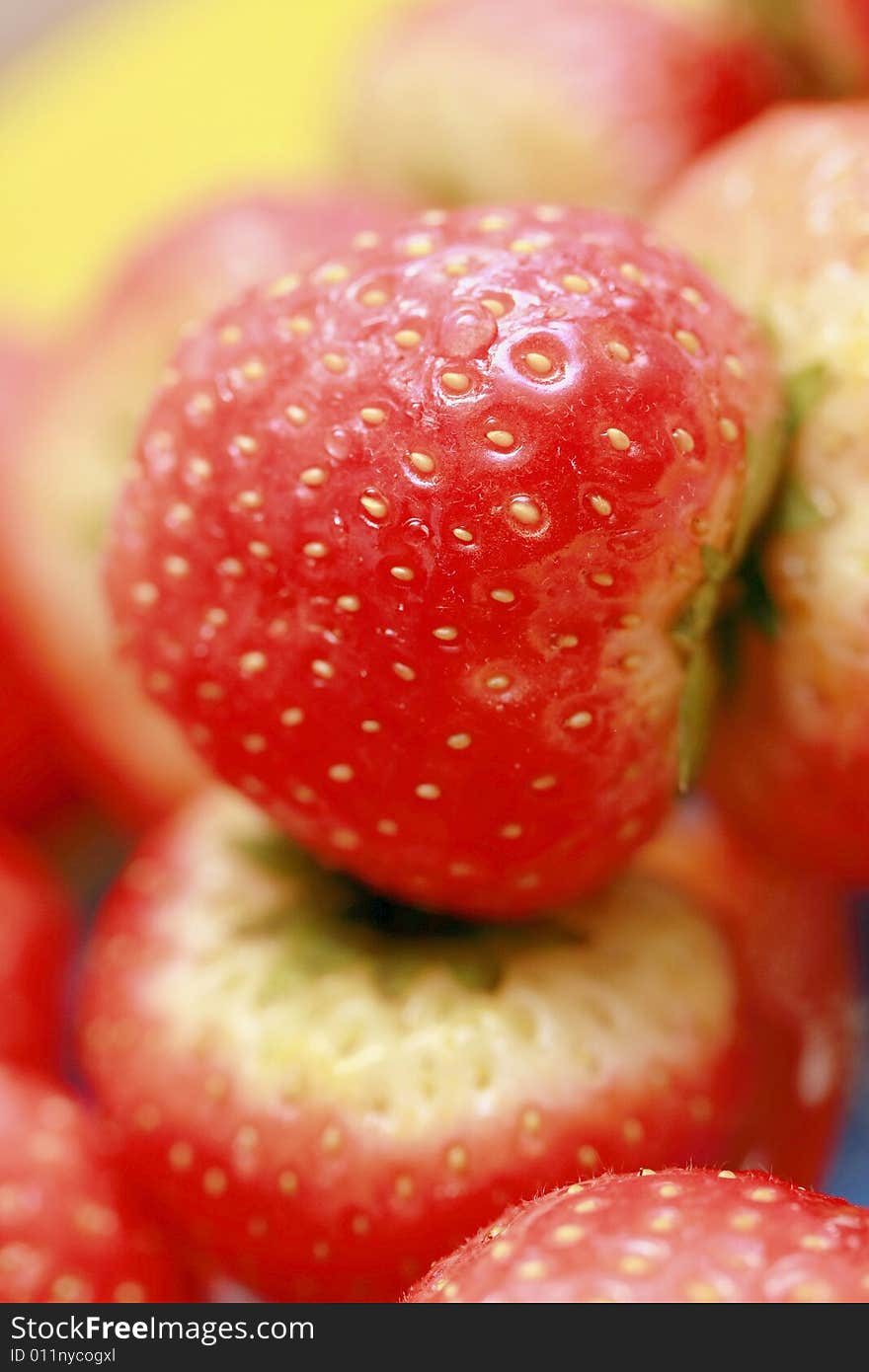 Many red small strawberries as background