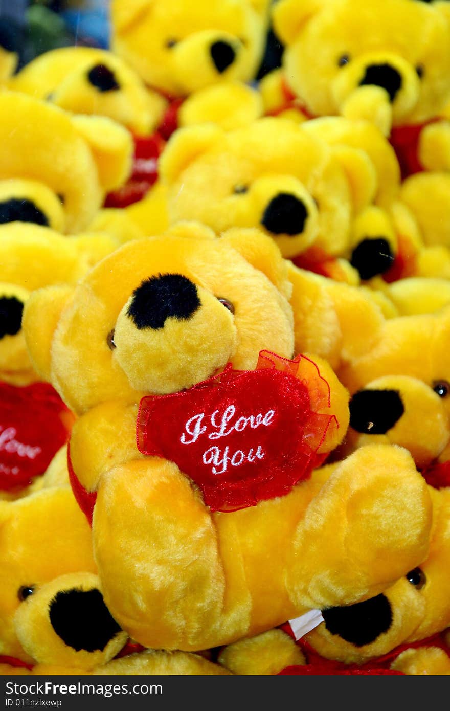 Many yellow toy bears with heart