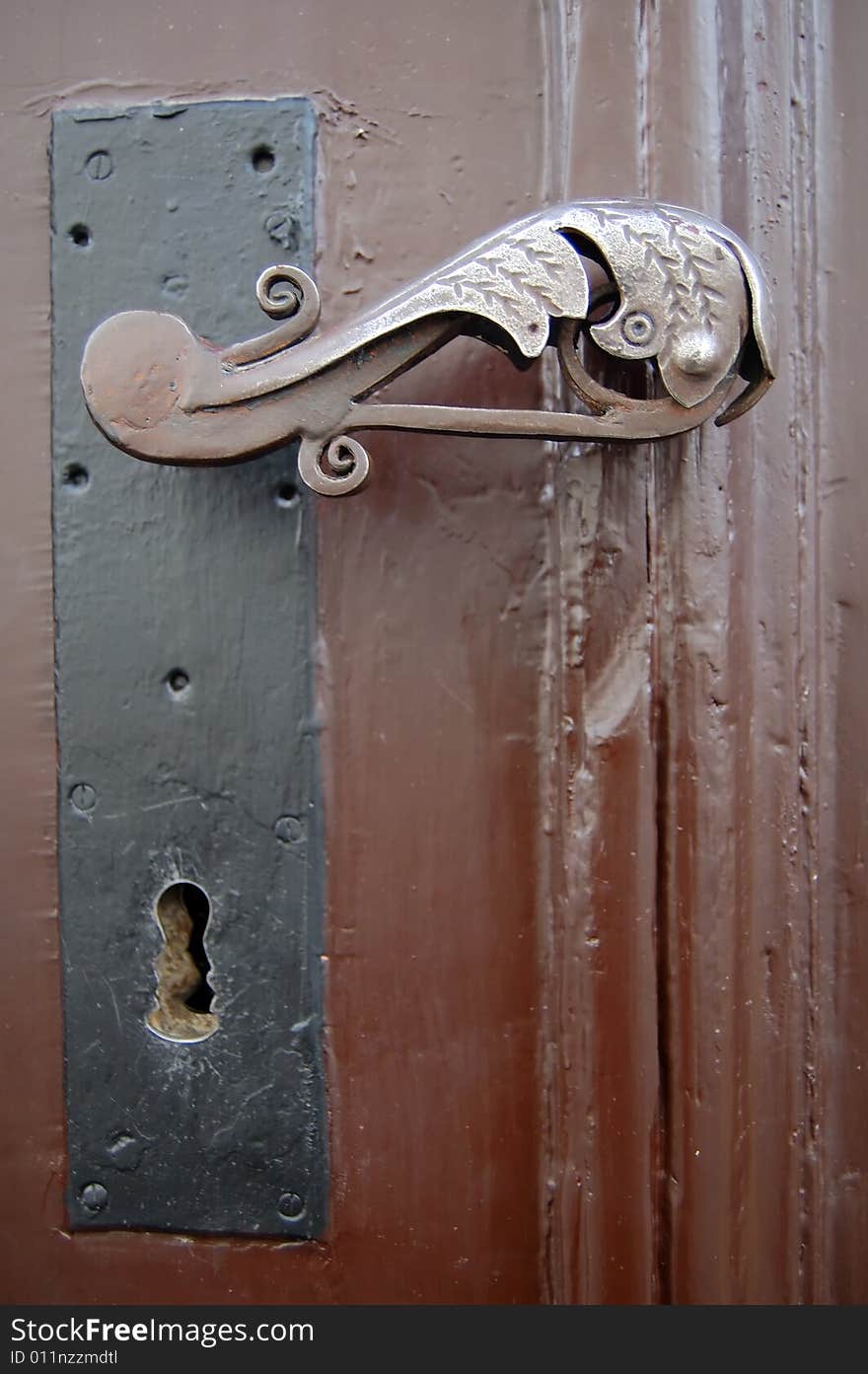 Old rusty door handle, brown door