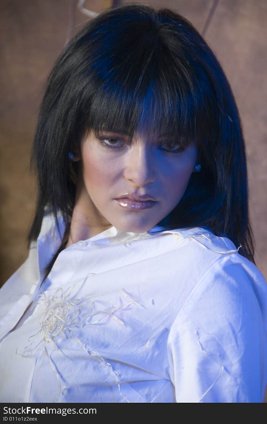 Portrait of a young lady with a white shirt with bits of straw.  There is a subtle blue tinge in her hair and on her face and shirt. Portrait of a young lady with a white shirt with bits of straw.  There is a subtle blue tinge in her hair and on her face and shirt.