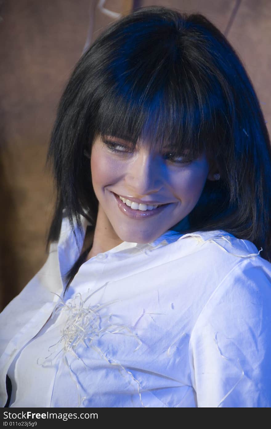 Portrait of a young lady smiling with a white shirt with bits of straw.  There is a subtle blue tinge in her hair and on her face and shirt. Portrait of a young lady smiling with a white shirt with bits of straw.  There is a subtle blue tinge in her hair and on her face and shirt.