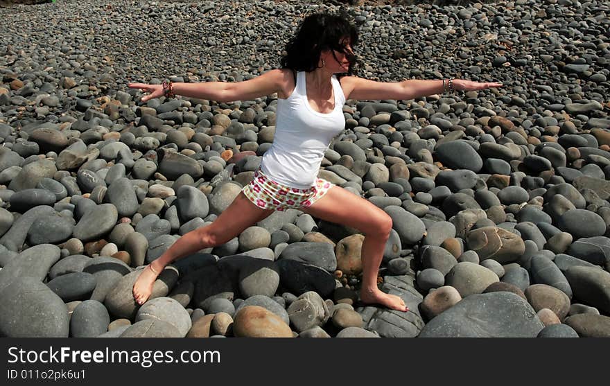 A beautiful woman doing yoga to show a healthy way to live a happy and relaxed lifestyle in a world full of stress. A beautiful woman doing yoga to show a healthy way to live a happy and relaxed lifestyle in a world full of stress