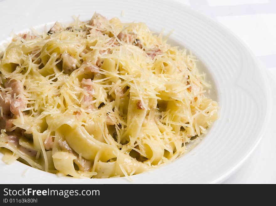 Macaroni with minced meat and cheese on white plate