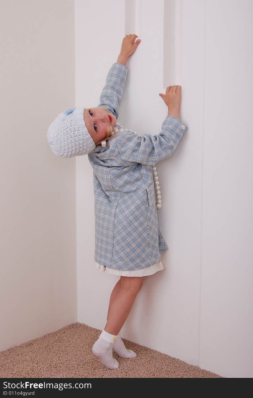 Pretty little girl in nice clothe and beads in studio