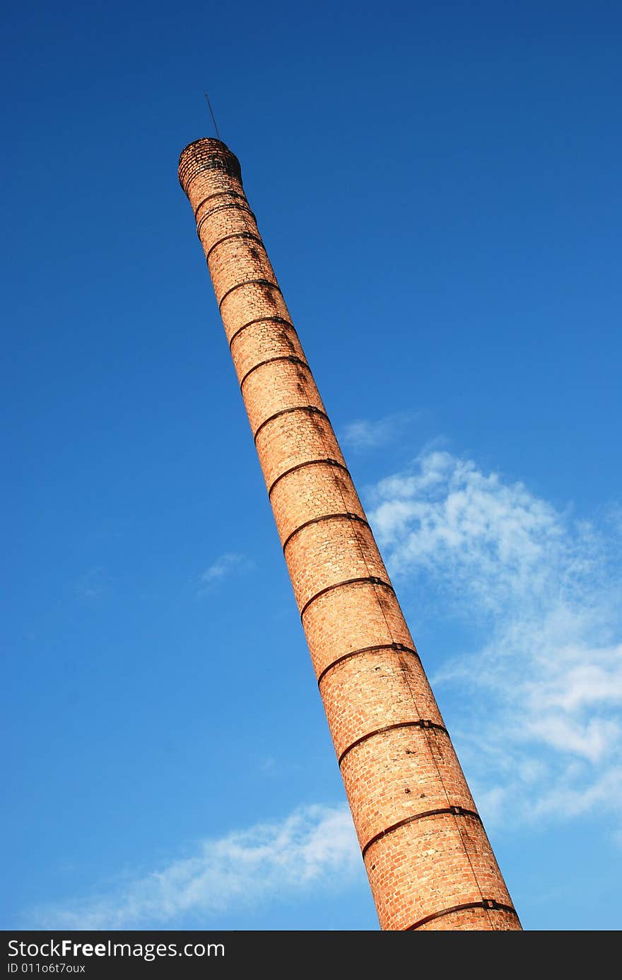 Tall brick tower towards the blue sky
