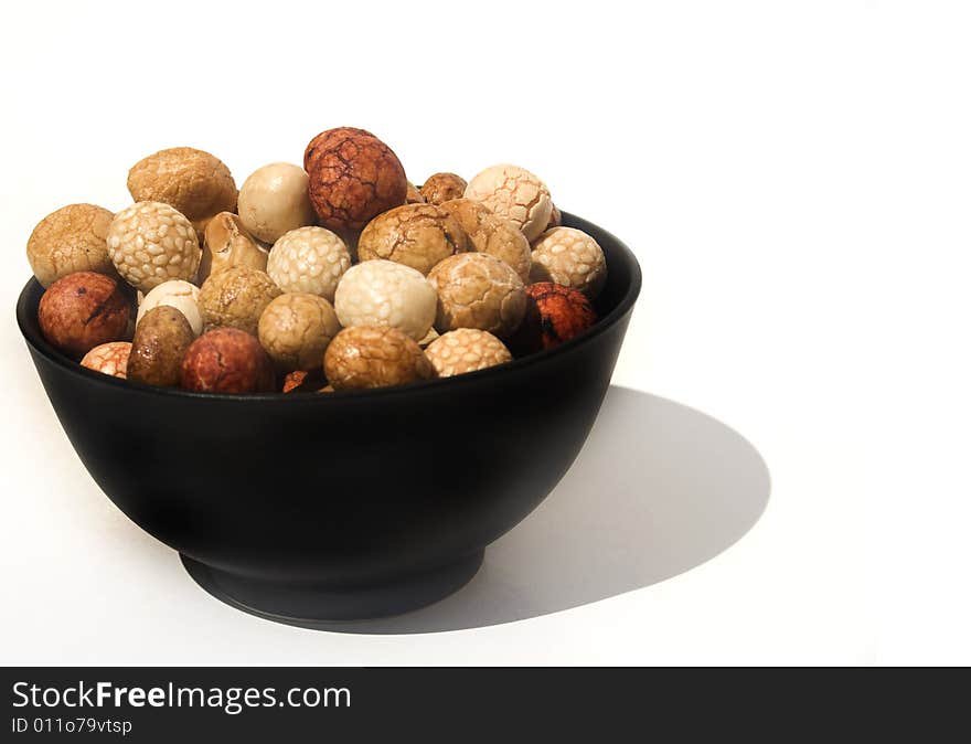 Bowl of Asian rice and sesame crackers against white background. Bowl of Asian rice and sesame crackers against white background