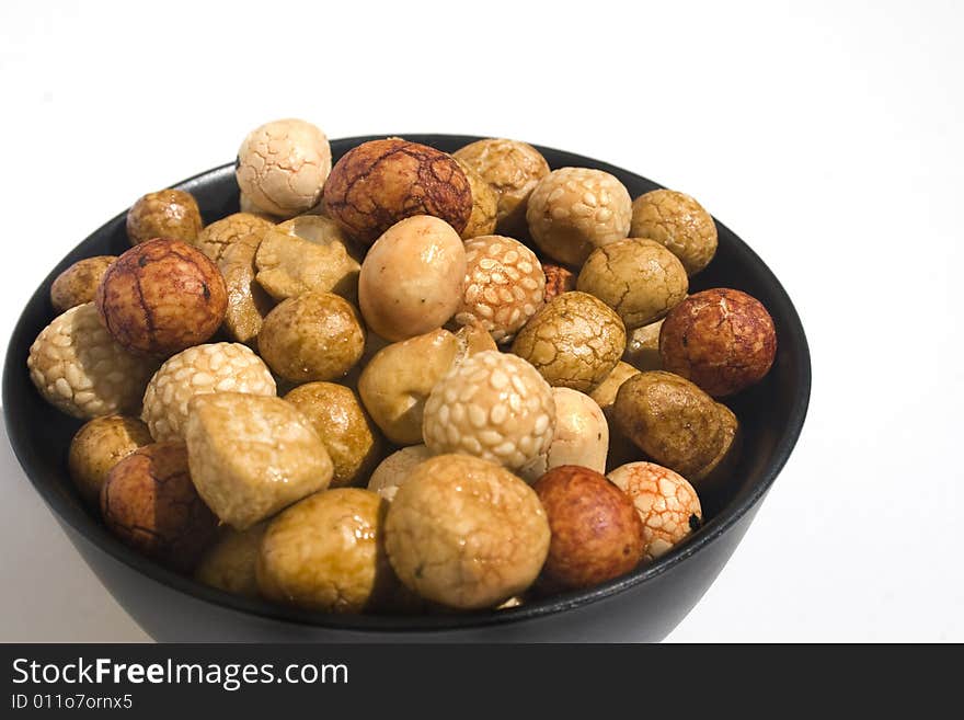 Bowl of Asian rice and sesame crackers against white background. Bowl of Asian rice and sesame crackers against white background