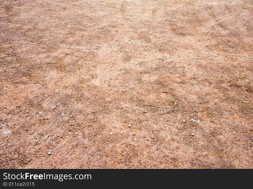 Red And Orange Gravel With Tire Tracks