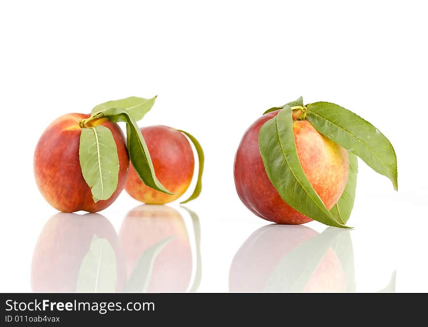 Ripe peach fruit with green leaf isolated on white background. Ripe peach fruit with green leaf isolated on white background