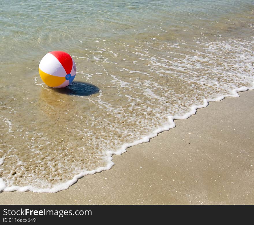 Colored beach ball on the beach