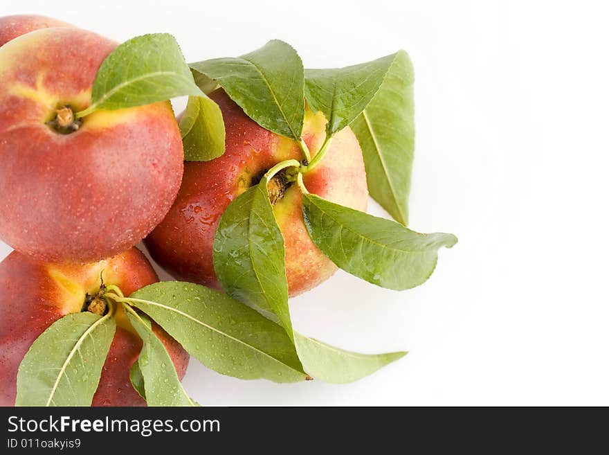 Ripe peach fruit with green leaf isolated on white background. Ripe peach fruit with green leaf isolated on white background